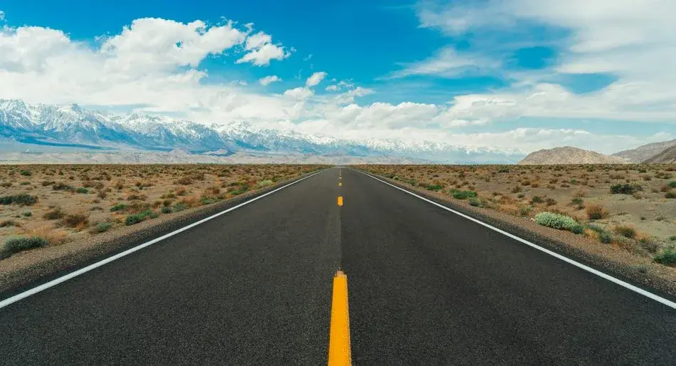 An open road stretching toward distant mountains